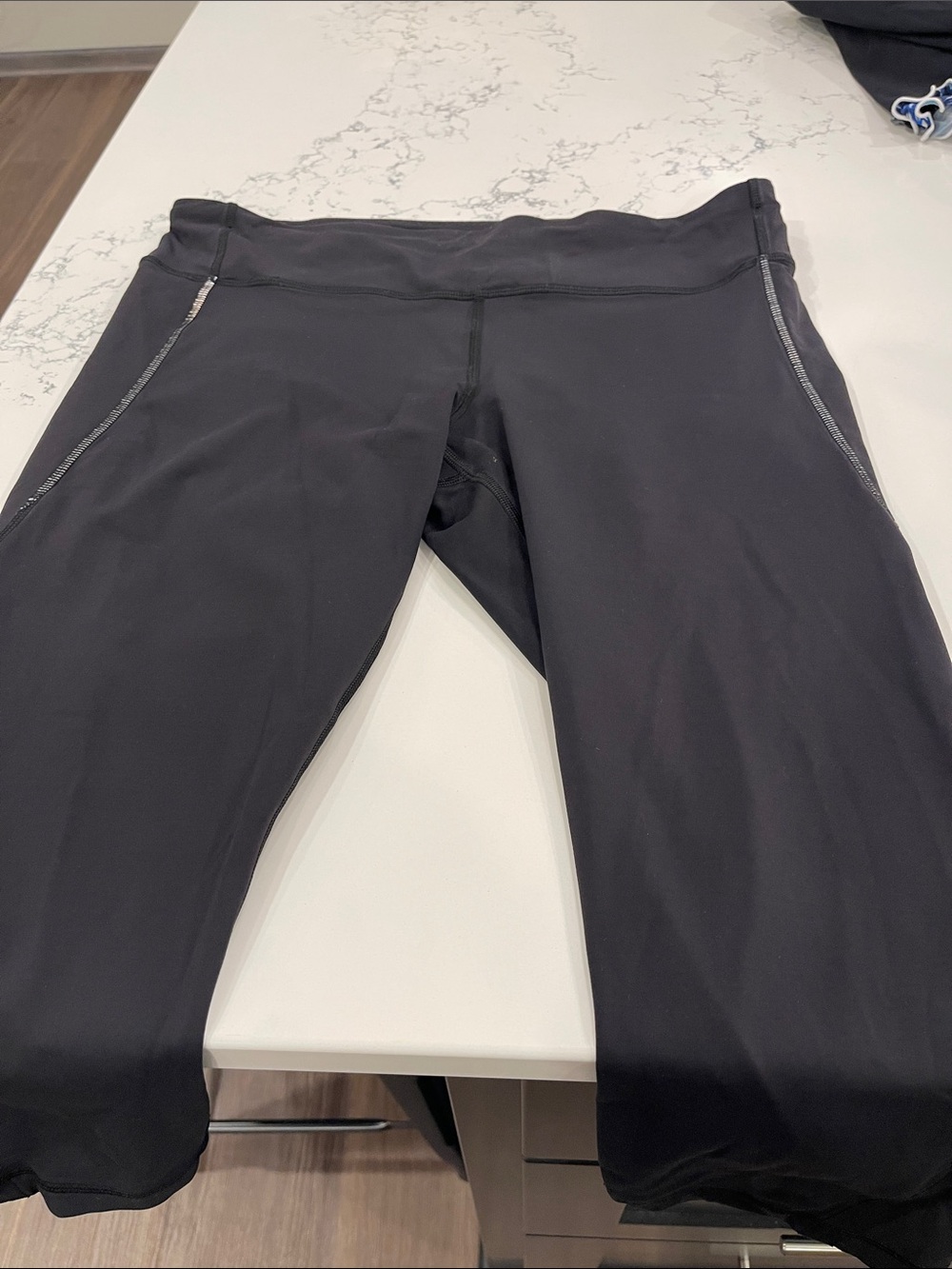 Women’s Lululemon 17 inch leggings. Back zipper pocket, reflective stitching.